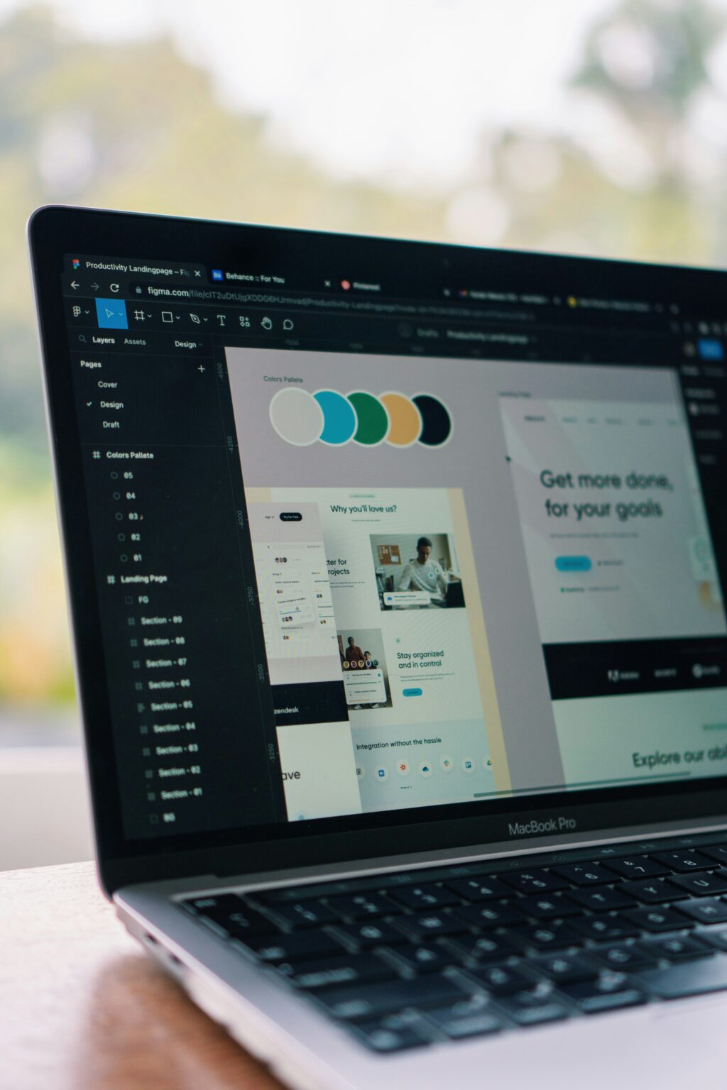 Laptop screen displaying a website design layout in Figma
