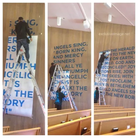 Team installing large custom wall lettering signage